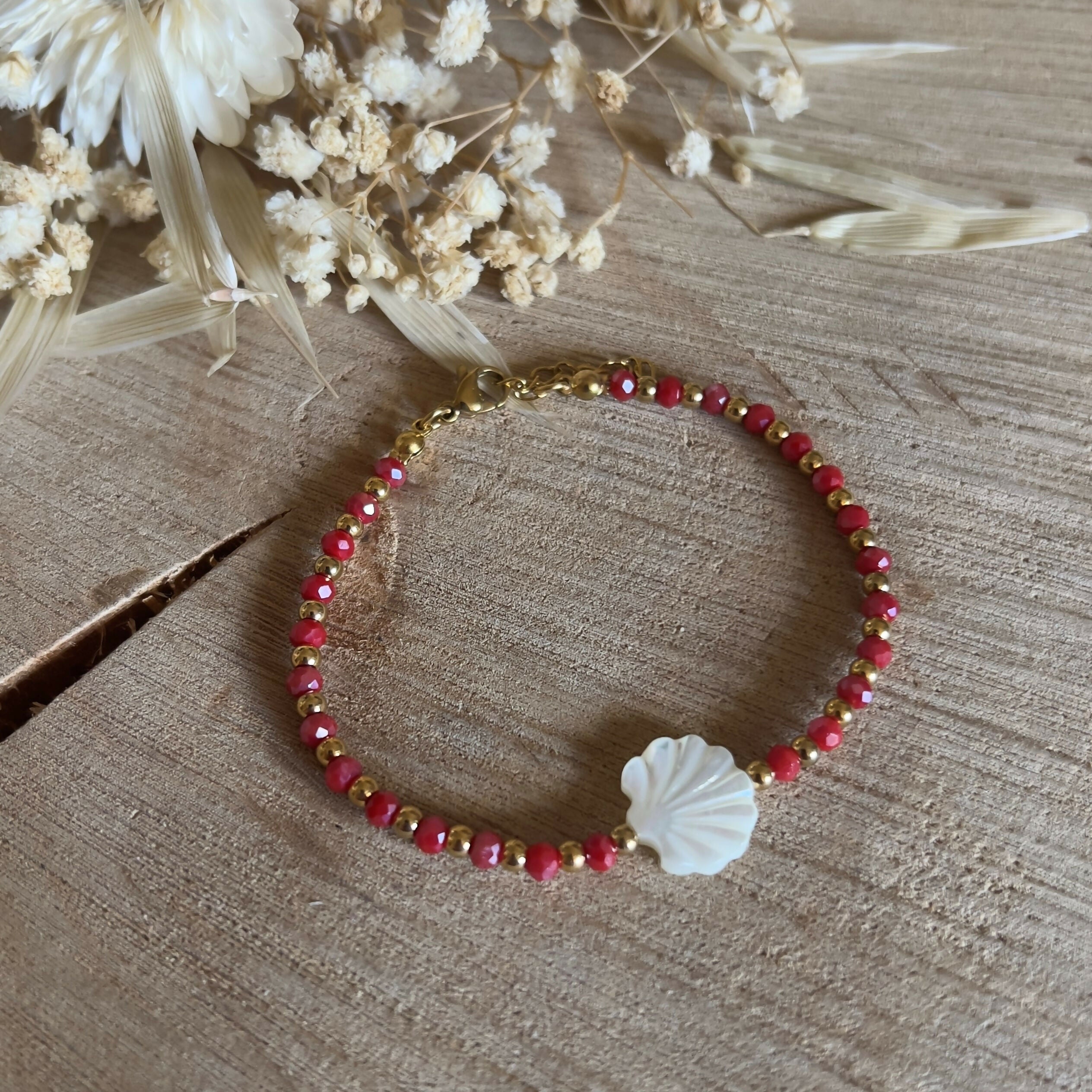 Red beaded bracelet, with small golden beads & a mother-of-pearl shell