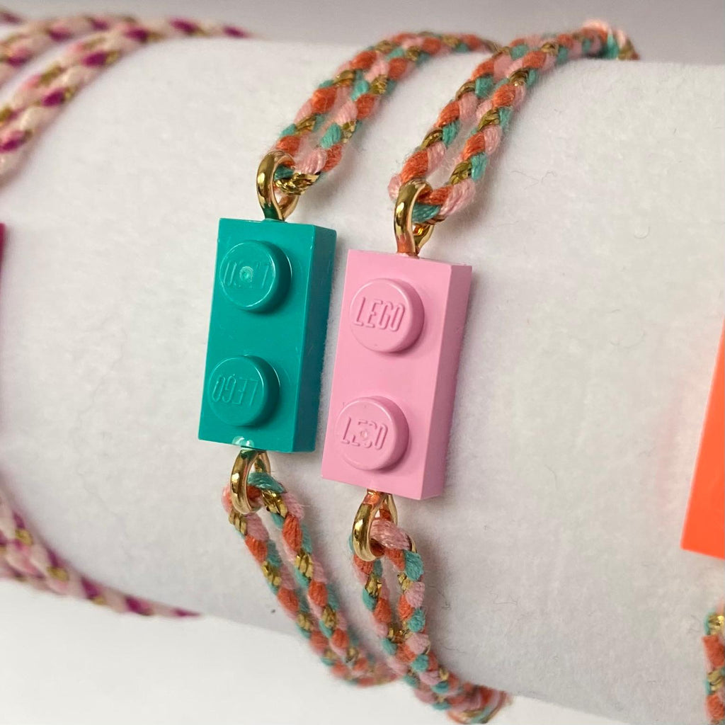Adjustable braided coral-green cord bracelet with matching Lego brick