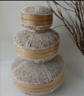 Beige beaded round box with a white cross